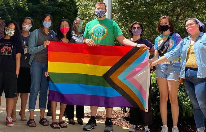 Sacramento City Councilman Steve Hansen, center, joined with LGBTQ members of his city's youth commission June 11 to raise the Progress Pride flag at City Hall. Photo: Courtesy Facebook