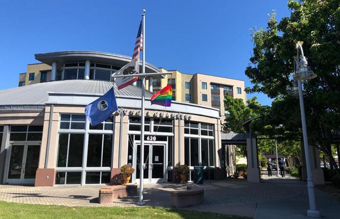 Foster City staff borrowed the rainbow flag from Island United UCC Church and raised it June 16 in front of City Hall. Photo: Courtesy Foster City