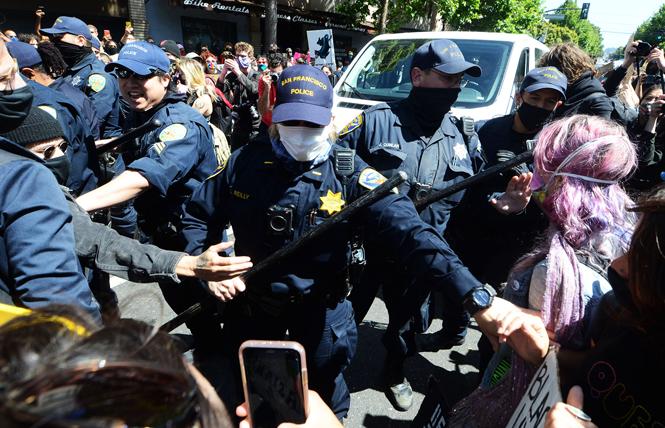 Police officers became aggressive and highly provocative when marchers surrounded their unmarked van during the Pride is a riot march Sunday, June 28. Photo: Rick Gerharter