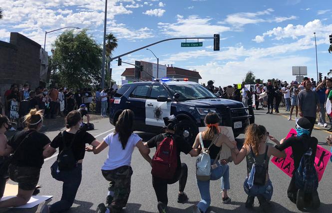 South Bay Assembly candidate Alex Lee took this photo in San Jose during protests against the police May 29. "We're Linked together as riot gear police show up," he wrote on Twitter. Photo: Alex Lee