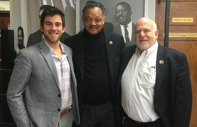 Jewish Community Relations Council's new executive director Tyler Gregory, left, and Jewish Community Federation and Endowment Fund board chair Arthur Slepian, right, with civil rights activist the Reverend Jesse Jackson, center, at the Creating Change Conference in Chicago. Photo: Courtesy Arthur Slepian