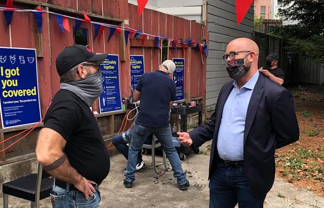 Joe Gallagher, left, talks with District 8 Supervisor Rafael Mandelman in the backyard of Joe's Barbershop ahead of personal services, including barber shops, gyms, fitness centers being allowed to resume indoor service — with restrictions — September 14. Photo: Courtesy Rafael Mandelman/Facebook