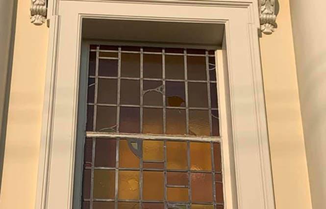 Boards protect a broken stained-glass window at Most Holy Redeemer Catholic Church in the Castro. Photo: Courtesy Facebook