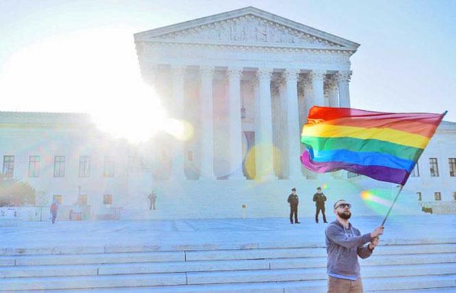 A person waves a rainbow flag outside of the U.S. Supreme Court. Photo: Scott Drake