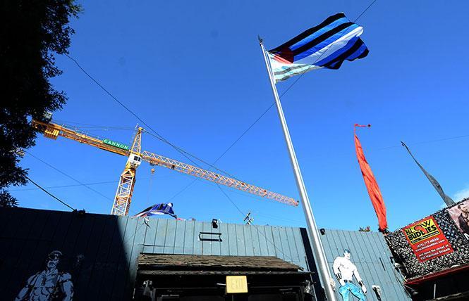 The leather pride flag flies at the Eagle bar in 2018 as construction continues on a mixed-use development that will pay for a leather-themed public plaza nearby. Photo; Rick Gerharter  