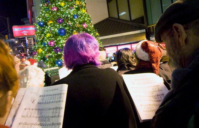 Carolers, joined by the San Francisco Lesbian/Gay Freedom Band, heralded the lighting of the annual Castro holiday tree in 2012. Photo: Rick Gerharter