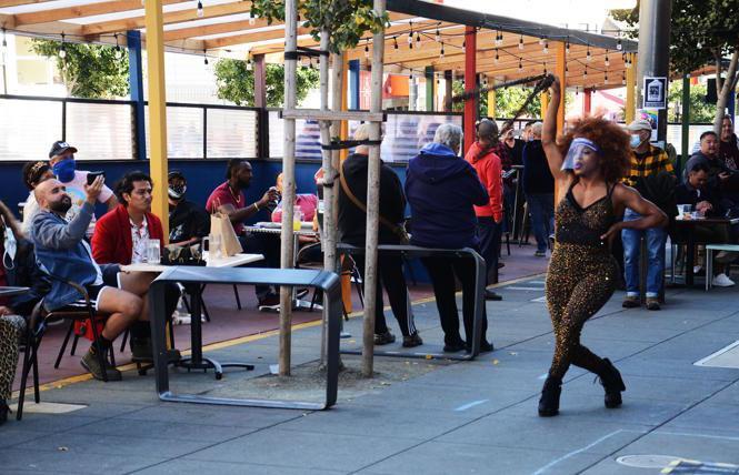 Outdoor dining, such as this October scene in the Castro featuring drag performer Militia Scunt, right, will end Sunday night in San Francisco and several other Bay Area jurisdictions under new stay-home orders. Photo: Rick Gerharter