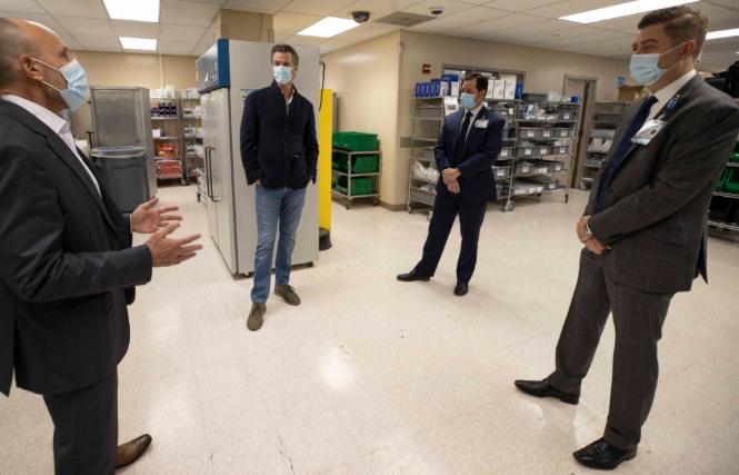 Governor Gavin Newsom, second from left, on December 11 visited an ultra-low temperature storage facility at UC Davis Medical Center, which is preparing for the imminent arrival of the Pfizer COVID-19 vaccine. Photo: Courtesy Governor's Office
