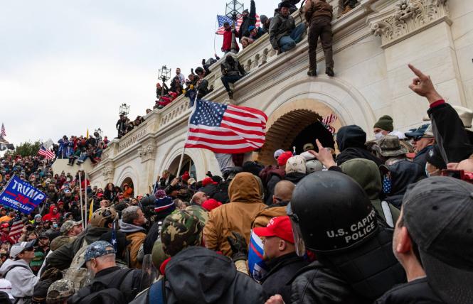 Members of a pro-Trump mob attempt to enter the U.S. Capitol building in Washington on Wednesday, January 6. Photo: Courtesy Bloomberg