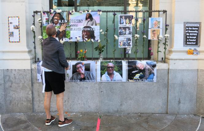 A person paid tribute to deceased community members outside the Castro Bank of America branch January 18. Photo: Gerard Koskovich 
