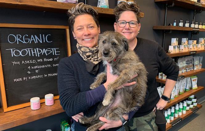 Jen Maxwell, left, holding Hazel, and her spouse, Kristi Maxwell, recently opened Maxwell's Pet Bar in Noe Valley. Photo: Sari Staver