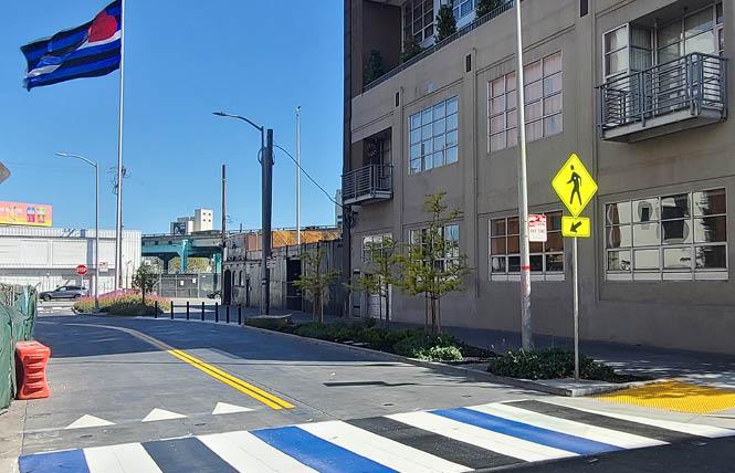 A new crosswalk sporting the blue, white, and black colors of the leather flag now marks the start of the Eagle Plaza public parklet on 12th Street at Bernice. Photo: Courtesy Leather & LGBTQ Cultural District