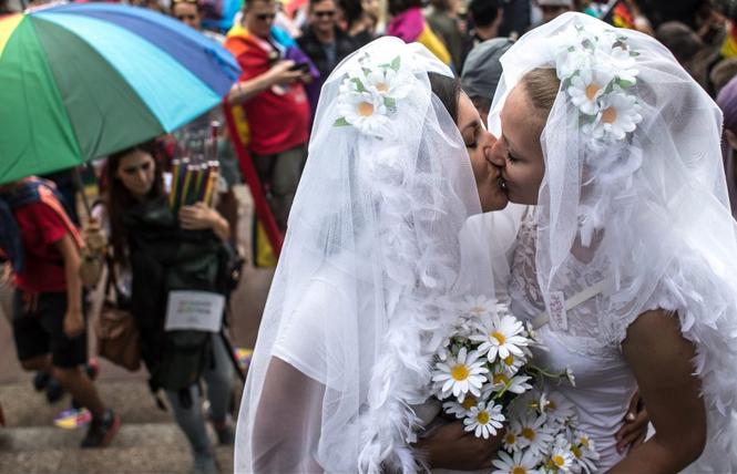 Women dressed as marriage equality brides kissed during Prague Pride in the Czech Republic. Photo: Courtesy Balkan Insight  