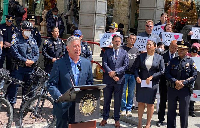 Joe D'Alessandro, at podium, joined Supervisor Ahsha Safaí, Mayor London Breed, and Police Chief William Scott to discuss an increase in patrol officers in different parts of the city during the summer travel season. Photo: John Ferrannini 