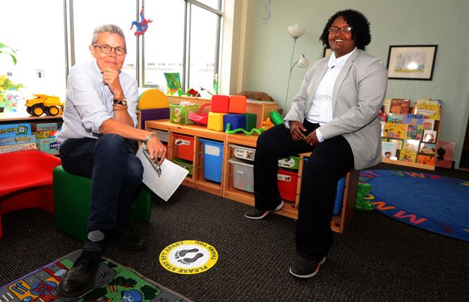 Pauly Pagenhart, left, Our Family Coalition communications director, and Mimi Demissew, executive director, sit in the children's play area in the organization's new offices. Photo: Rick Gerharter