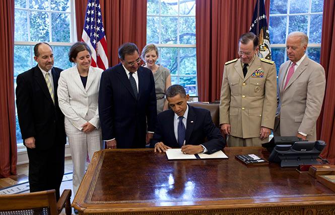 President Barack Obama signs the certification stating the statutory requirements for repeal of "Don't Ask, Don't Tell" have been met, in the Oval Office, July 22, 2011. Pictured, from left, are: Brian Bond, deputy director of the Office of Public Engagement; Kathleen Hartnett, associate counsel to the president; Secretary of Defense Leon Panetta; Kathryn Ruemmler, counsel to the president; Chairman of the Joint Chiefs of Staff Admiral Mike Mullen; and Vice President Joe Biden. White House photo: Pete Souza