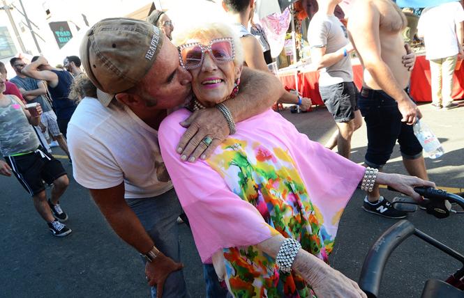 Jim Koran gave his 86-year-old mother, Christina Fast, visiting from Scottsdale, Arizona, a hug and a kiss as they made their way through the crowd at the 2018 Castro Street Fair. Photo: Rick Gerharter