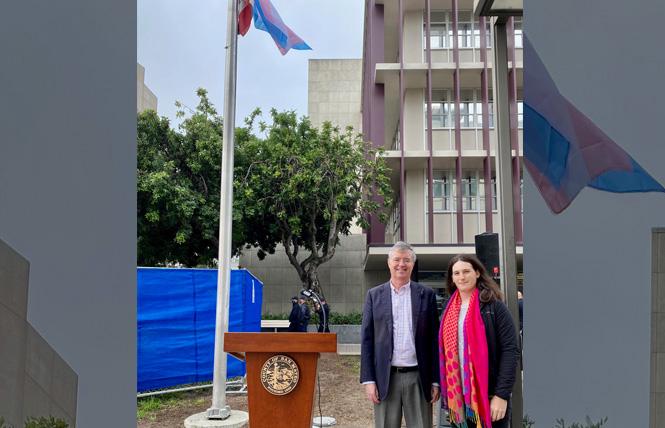 San Mateo County Supervisor Dave Pine, left, and Jenna Weiner, program director from Adolescent Counseling Service/Outlet and the San Mateo County Pride Center, stood in front of the transgender flag that was raised at the County Center in Redwood City. Photo: Courtesy LGBTQ Commission/Tanya Beat