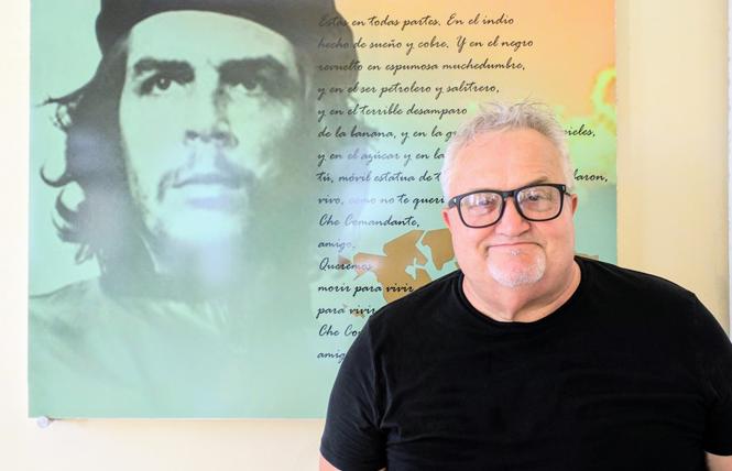 Scott Robbe stands in front of art depicting Che Guevara. Photo: Courtesy Scott Robbe Estate