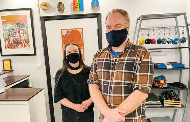 Employee Brynn Soderlund, left, and assistant manager Andy Eaglesham stand inside Local Take, which Eaglesham said has largely survived the COVID pandemic. Photo: Eric Burkett