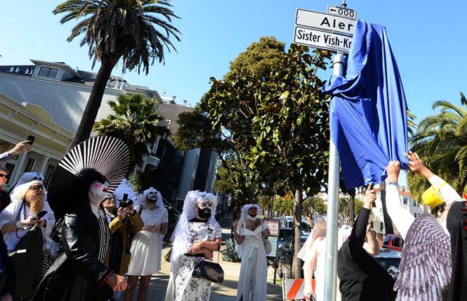 After a little difficulty of removing the cloth, the new street sign for Sister Vish-Knew Alley was revealed in a sidewalk ceremony April 16. Sister Vish-Knew, aka Kenneth Bunch, left, and over 20 Sisters were there to celebrate. Photo: Rick Gerharter