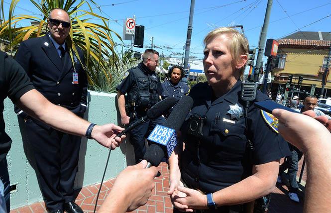San Francisco Police Officer Kathryn Winters speaks in opposition to San Francisco Pride's prohibition of uniformed officers marching in the parade during a May 20 news conference. Lieutenant Jonathan Baxter of the San Francisco Fire Department, back, left, also spoke. Photo: Rick Gerharter<br><br>