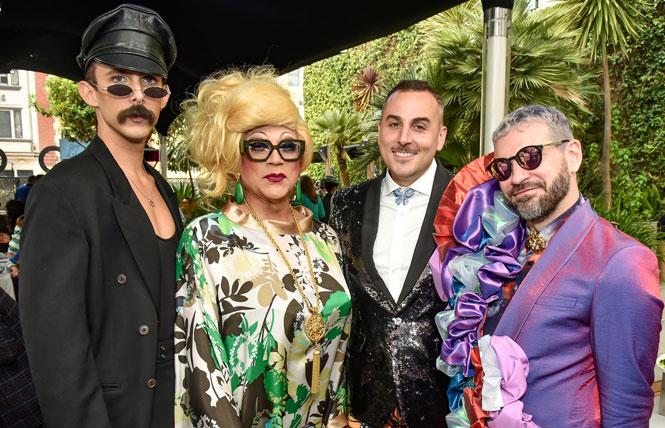 John Ross Thomas, left, a Queer LifeSpace volunteer and florist for the event, joined honoree Juanita MORE!, QLS Executive Director Ryan MacCarrigan, and QLS co-founder Chris Holleran at the organization's May 7 gala. Photo: Gooch<br>