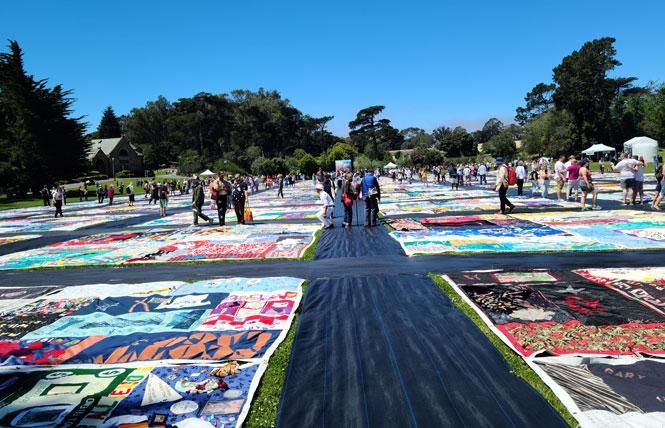 People walk along pathways as they look at the AIDS Memorial Quilt in Golden Gate Park June 11. Photo: Cynthia Laird