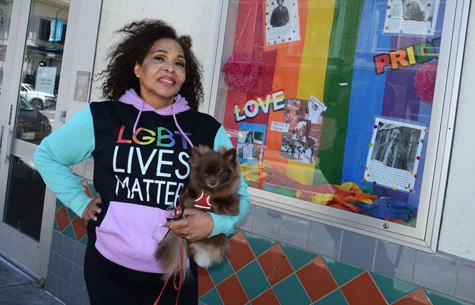 Andrea Horne, this year's San Francisco Pride lifetime achievement grand marshal, holds her dog Mei-Mei outside the Curry Senior Center, where Horne has been a community engagement worker for the mature trans community. Photo: Rick Gerharter