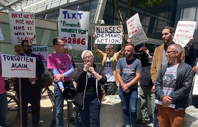 Laura Thomas from the San Francisco AIDS Foundation urged a quicker federal response to monkeypox at a July 18 rally outside the local offices of the U.S. Department of Health and Human Services. Photo: Liz Highleyman<br>