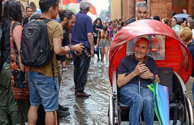 Franco Grillini, a gay former member of the Italian parliament, is pushed through Bologna Pride by his lifelong friend and filmmaker Filippo Vendemmiati. Photo: Courtesy of Genoma Films Production