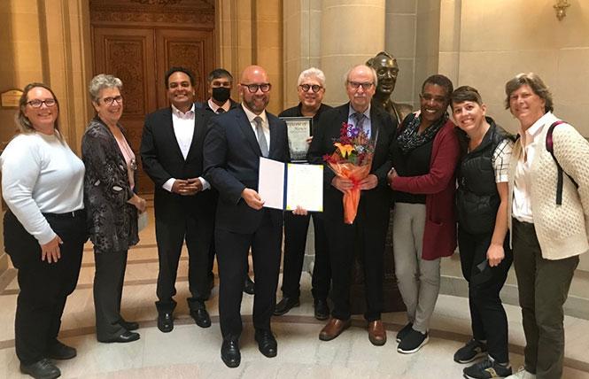 Tom Nolan, fourth from right holding a bouquet, was honored by District 8 Supervisor Rafael Mandelman July 19 for his nearly four decades of public service. August 2 was declared Tom Nolan Day in San Francisco. Photo: Courtesy Facebook<br>