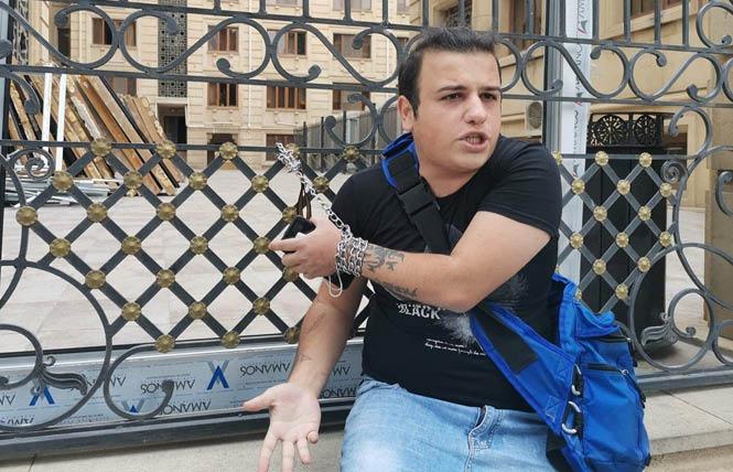In 2021, Avaz Hafizli made a name for himself by chaining himself to the fence outside the chief prosecutor's office for what he claimed was its insufficient action against anti-LGBTQ threats toward the country's queer community. Photo Courtesy ILGA-Europe<br>
