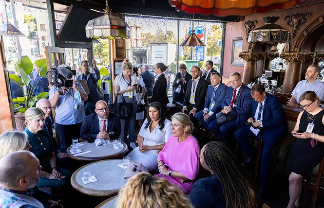 Queen Máxima of the Netherlands, in pink dress seated next to San Francisco Mayor London Breed, talked with LGBTQ leaders inside Twin Peaks Tavern during her September 6 visit to the Castro neighborhood. Photo: San Francisco Chronicle/pool<br>