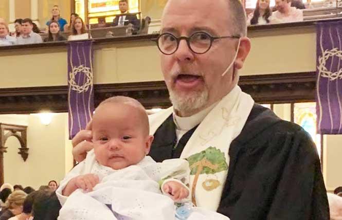 The Reverend Victor H. Floyd holds a newly-baptized baby boy during a church service. Photo: Courtesy Victor H. Floyd; baby photographed with permission