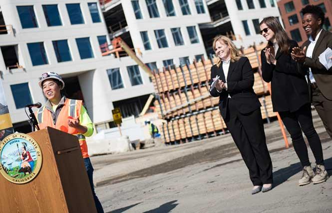 Mission Rock Academy graduate, Anna Fung, left, spoke at a press event announcing new state investment to increase access and equity in construction careers at a Mission Rock construction site on Tuesday, October 11. Photo: Christopher Robledo
