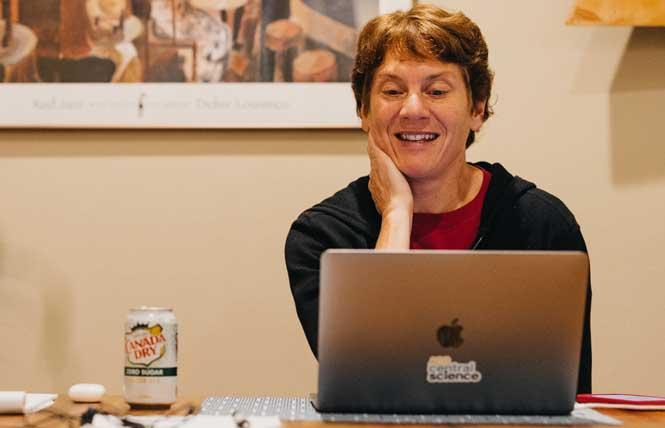 Stanford University chemistry Professor Carolyn Bertozzi sits at her desk at Stanford on October 5, the day she was co-awarded the prize in chemistry. Photo: Courtesy Andrew Brodhead/Stanford University