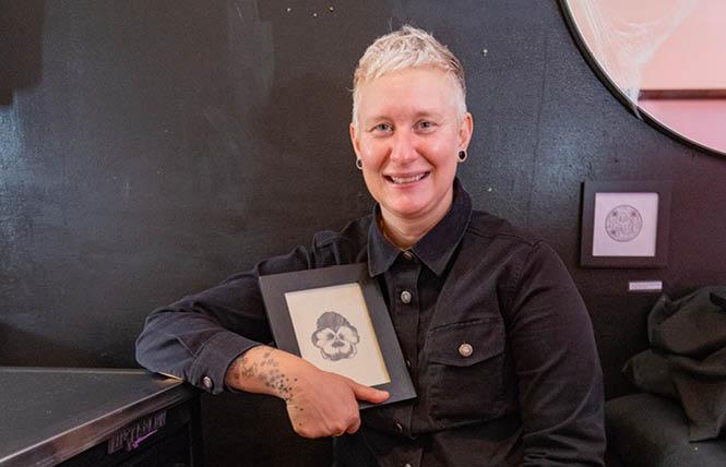 Oakland tattoo artist Cedre Csillagi, holding an image of the pansy tattoo, has launched A Thousand Pansies to help benefit an LGBTQ organization in Selma, Alabama. Photo: Jane Philomen Cleland