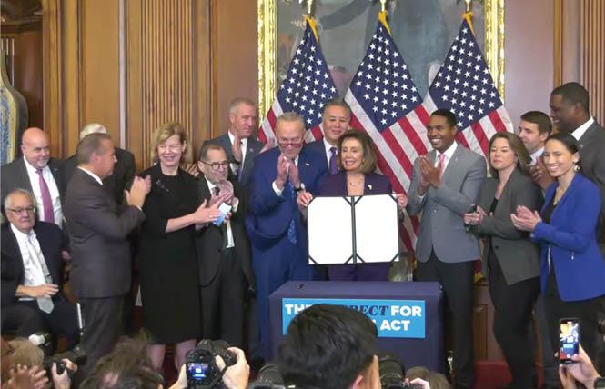 House Speaker Nancy Pelosi holds the Respect for Marriage Act bill that will soon be sent to President Joe Biden for his signature. Photo: Screengrab