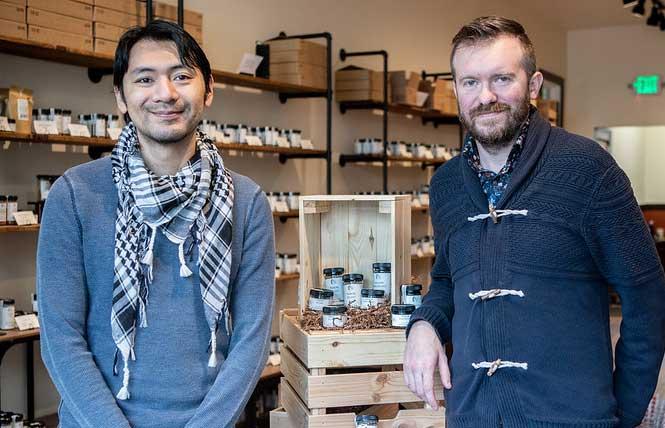 Perfectly Seasoned co-owners Phuong Mai, left, and his fiancé Matthew Green stand next to a display of spices at their Noe Valley store. Photo: Art Bodner