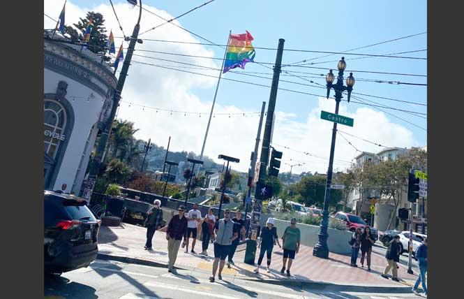 People cross Castro Street at Market Street. Neighborhood leaders and residents hope the LGBTQ neighborhood can continue recovering from the COVID pandemic. Photo: John Ferrannini