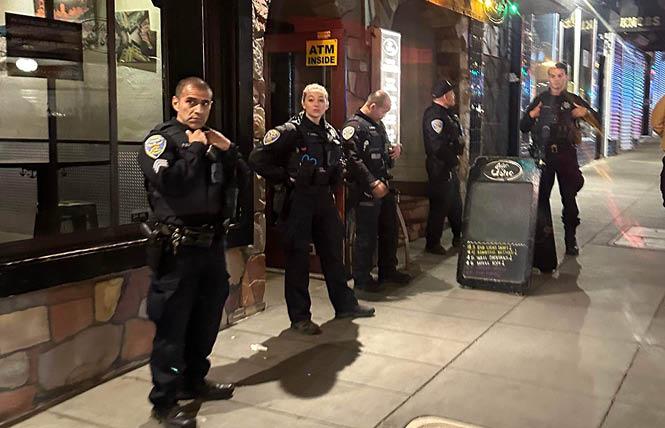 San Francisco police officers stand outside bar 440 Castro early Saturday morning as they investigated a possible bomb threat. Photo: Jose Ruiz Wilbert<br>
