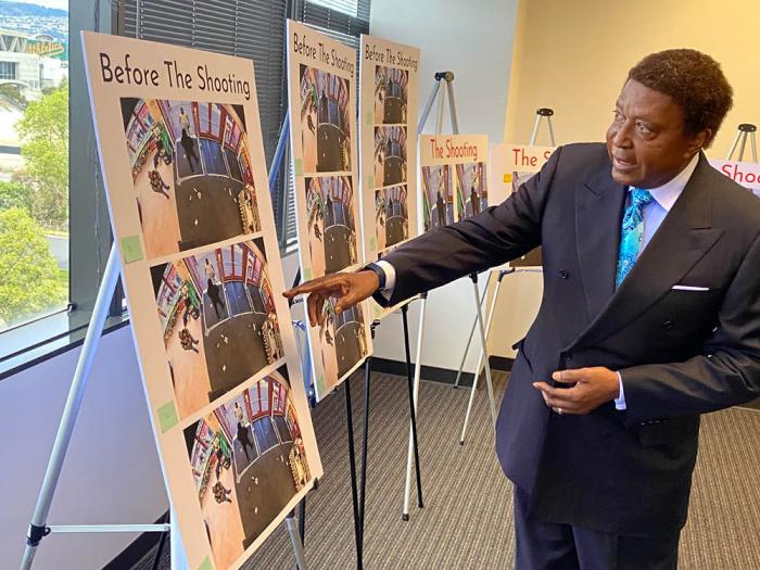 Attorney John Burris points to an enlarged photo of the Walgreens security guard and Banko Brown just before Brown was shot. Photo: John Ferrannini