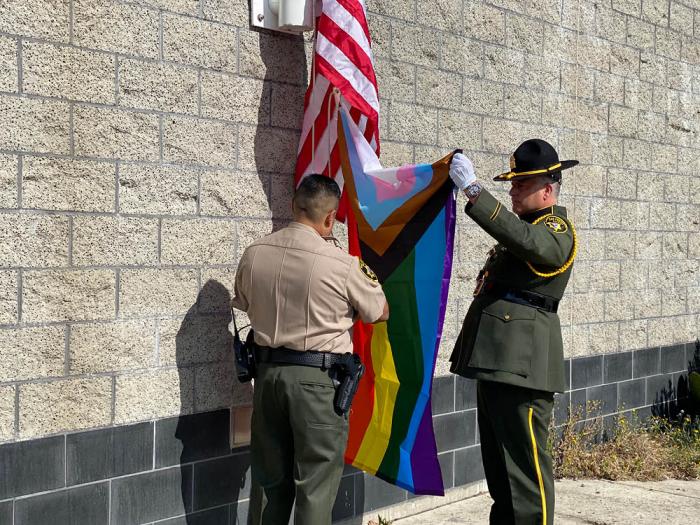 San Francisco Sheriff's Lieutenant J. Pineda, left, was assisted by sheriff's Deputy B. Staehely in raising the Progress Pride flag June 5 at San Francisco County Jail No. 3. Photo: John Ferrannini