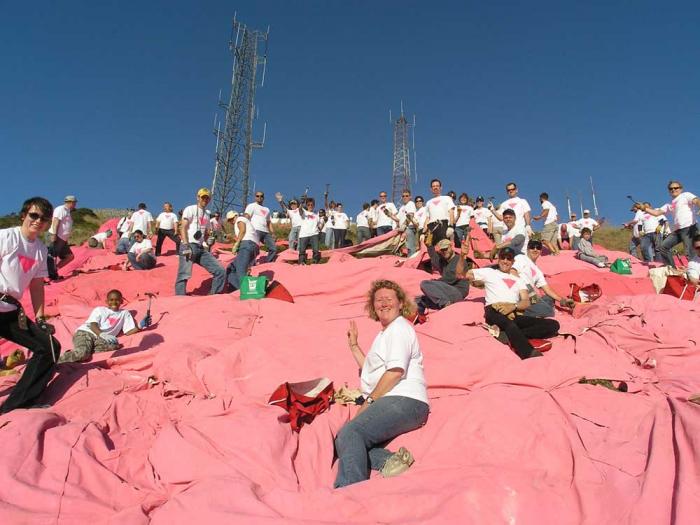 Bernadette Scully, center, joined other volunteers in putting together the canvas tarps that form the pink triangle atop Twin Peaks in 2009. Photo: Hossein Carney