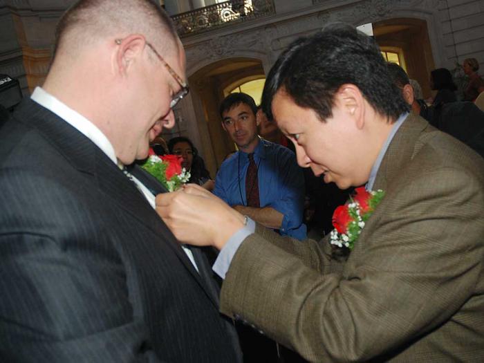 Amos Lim, right, carefully pinned a corsage on his soon-to-be-husband, Mickey Lim, during the first day of same-sex marriages in California on June 17, 2008. Photo: Rick Gerharter<br>