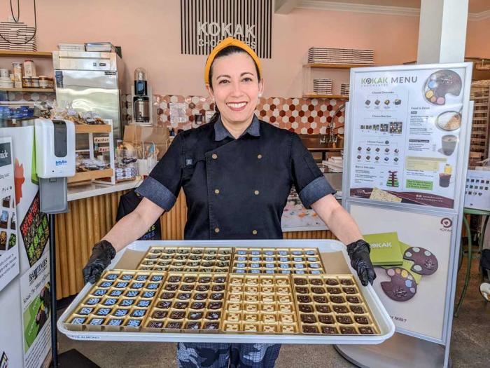 Kokak Chocolates founder and head chocolatier Carol Gancia holds a tray of delectable confections. Photo: Courtesy Kokak Chocolates