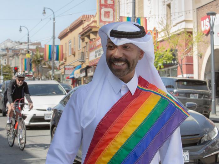 Gay Qatari Dr. Nasser Mohamed wore traditional Qatari garb with a rainbow sash as he walked through the Castro District in San Francisco. Photo: Dan Nicoletta