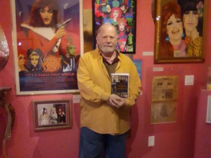 Author William Lipsky holds a copy of his book on LGBTQ historical figures. Photo: Brian Bromberger