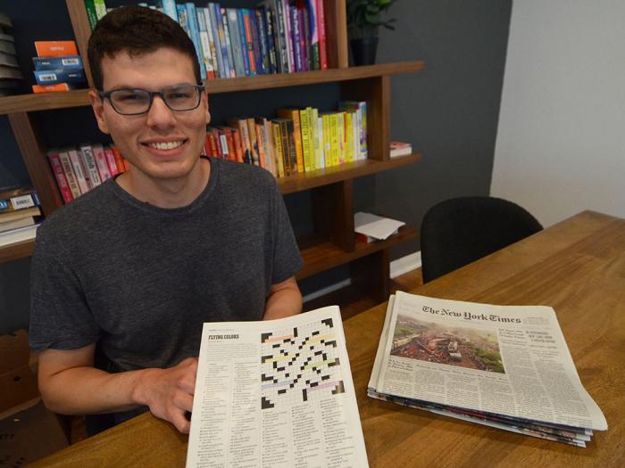 Rafael Musa holds his Pride-themed crossword puzzle that appeared in the June 4 issue of the Sunday New York Times Magazine. Photo: Rick Gerharter